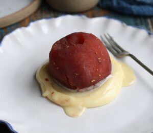 vegan raspberry poached apple with white chocolate sauce