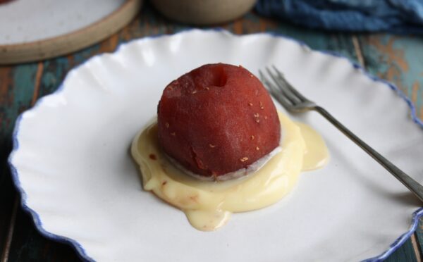 vegan raspberry poached apple with white chocolate sauce
