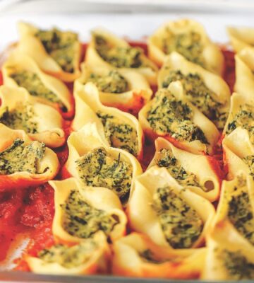 jumbo ricotta and spinach stuffed shells with tofu ricotta, onion, basil, olive oil, and vegan parm