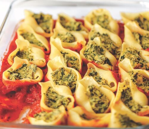 jumbo ricotta and spinach stuffed shells with tofu ricotta, onion, basil, olive oil, and vegan parm
