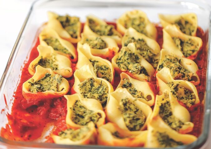 jumbo ricotta and spinach stuffed shells with tofu ricotta, onion, basil, olive oil, and vegan parm