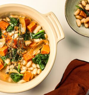 A pot of sweet potato one-pot warmer with spinach, white beans, and garlic