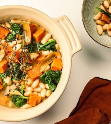 A pot of sweet potato one-pot warmer with spinach, white beans, and garlic