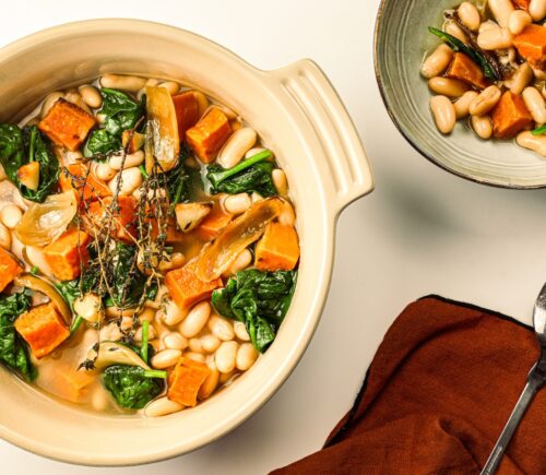 A pot of sweet potato one-pot warmer with spinach, white beans, and garlic