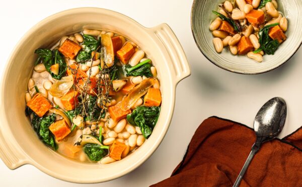 A pot of sweet potato one-pot warmer with spinach, white beans, and garlic