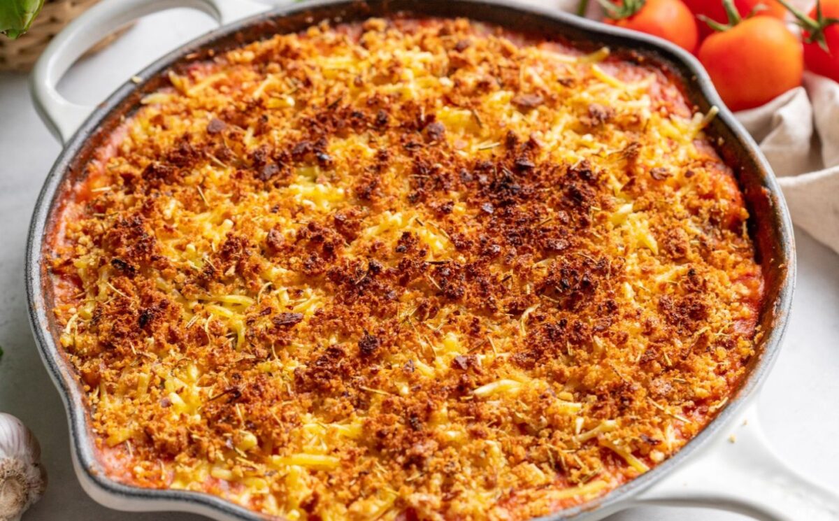 a pan of creamy one-pot gnocchi bake made with vegan cheese, tomatoes, and spinach for nourishing one pot meals