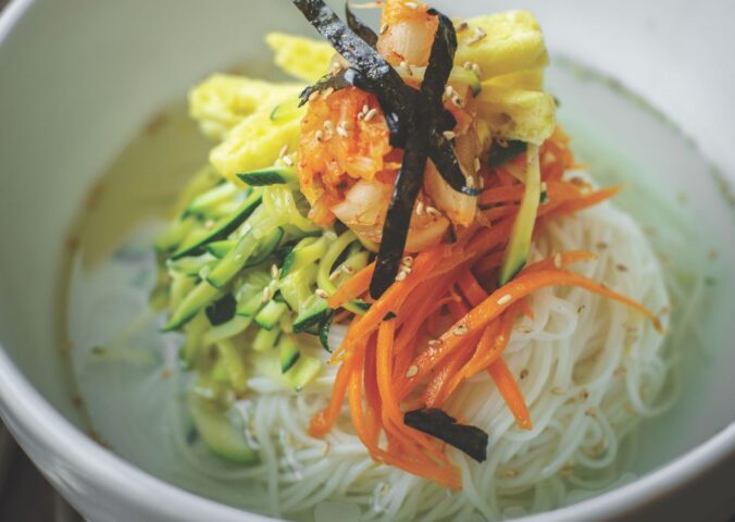 veggie noodles or janchi guksu with thin wheat noodles, radish, soy sauce, sliced onion, and zucchini