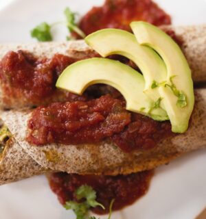 very veggie burritos or enchiladas with pepper, kale, beans, salsa, and avocado