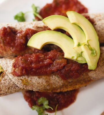 very veggie burritos or enchiladas with pepper, kale, beans, salsa, and avocado