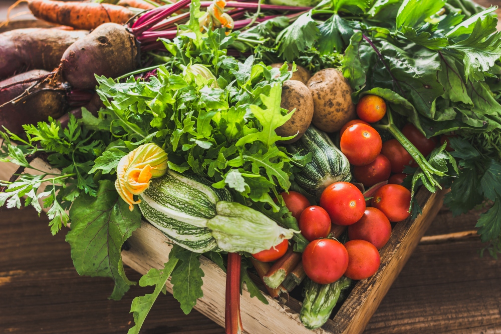 Assortment of fresh organic vegetables and garden produce at a farmer's market, to illustrate article about which fruits and vegetables to peel
