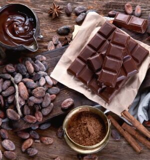 Cacao beans, powder, cacao butter, chocolate bar and chocolate sauce to illustrate the health benefits of chocolate