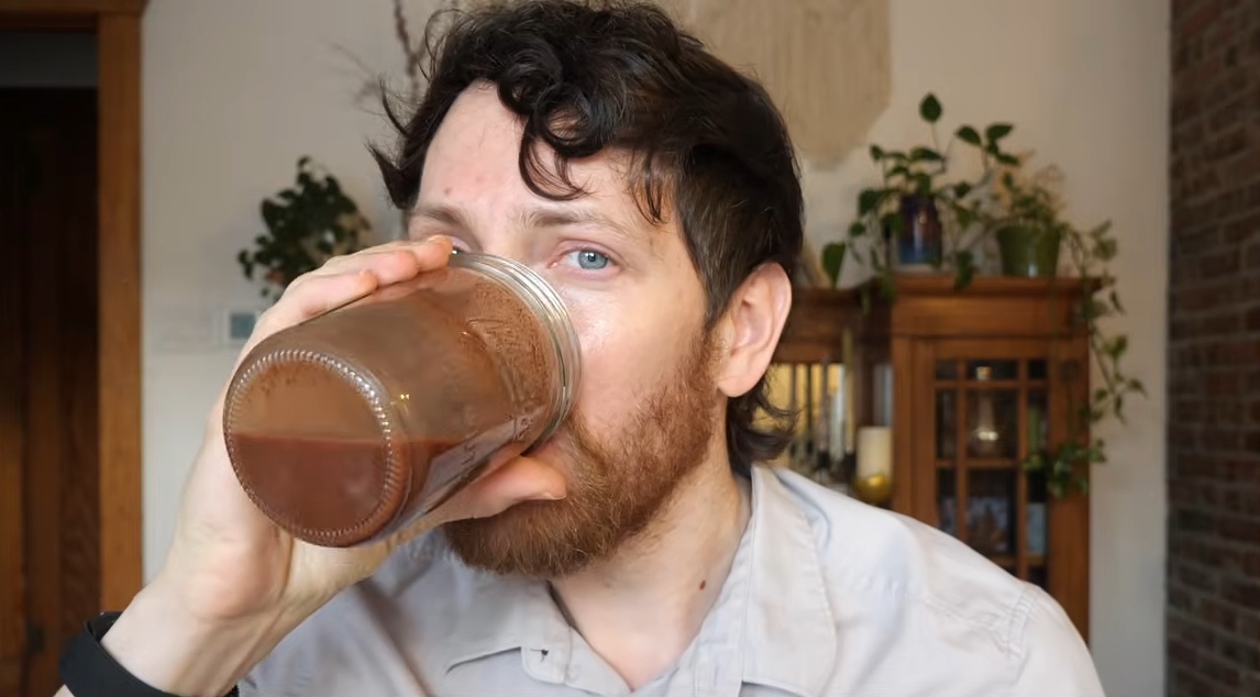 Mic the Vegan drinking vegan chocolate milk to illustrate the health benefits of chocolate