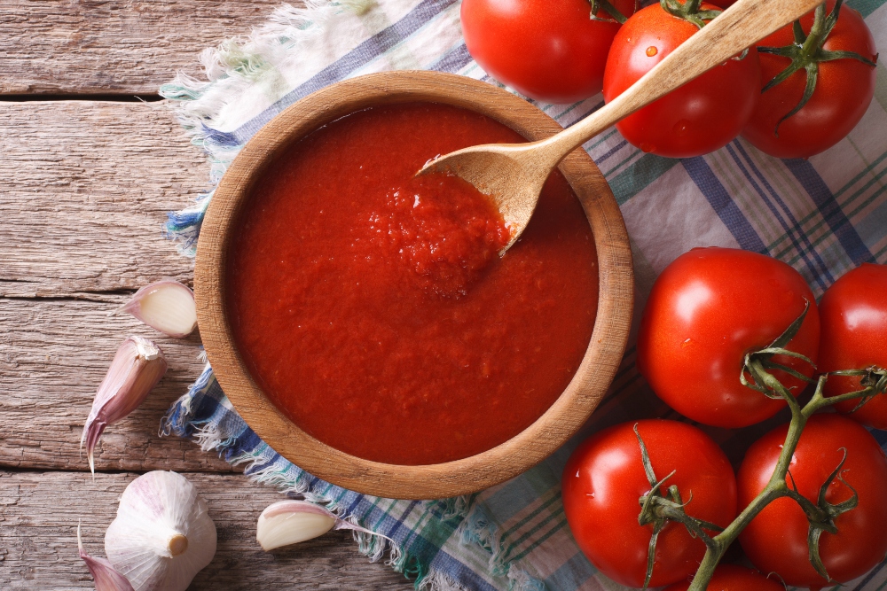 Tomato sauce with garlic and basil in a bowl closeup, to illustrate article about low fat vegan diet