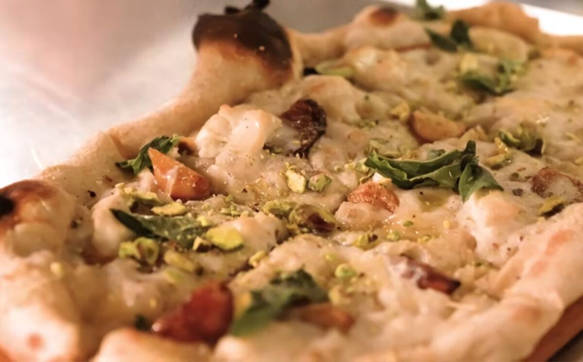 Baked pizza from Millennium restaurant topped with Miyoko's fermented vegan mozzarella that has melted and set in the oven