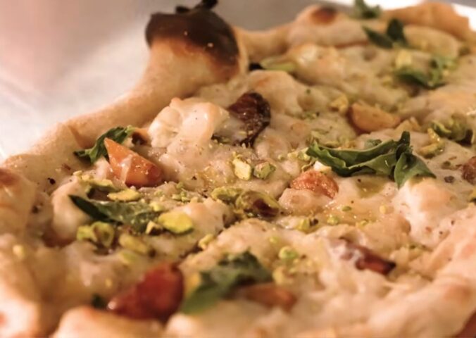 Baked pizza from Millennium restaurant topped with Miyoko's fermented vegan mozzarella that has melted and set in the oven