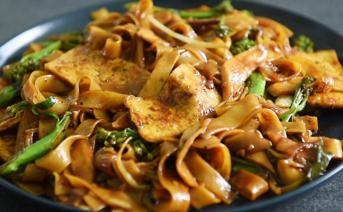 One of three vegan Chinese New Year recipes, this chow-fun style noodle dish contains tofu, broccolini, mushrooms, and bean sprouts