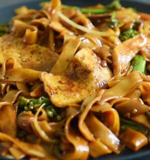 One of three vegan Chinese New Year recipes, this chow-fun style noodle dish contains tofu, broccolini, mushrooms, and bean sprouts
