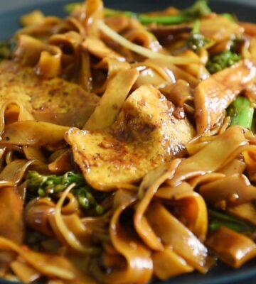 One of three vegan Chinese New Year recipes, this chow-fun style noodle dish contains tofu, broccolini, mushrooms, and bean sprouts
