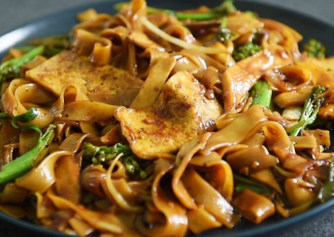 One of three vegan Chinese New Year recipes, this chow-fun style noodle dish contains tofu, broccolini, mushrooms, and bean sprouts