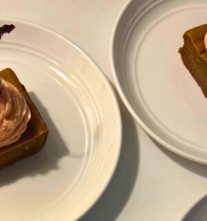 a photo of banana split butter mochi with strawberry buttercream and cherries
