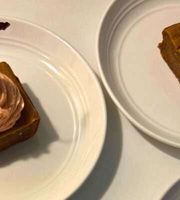 a photo of banana split butter mochi with strawberry buttercream and cherries