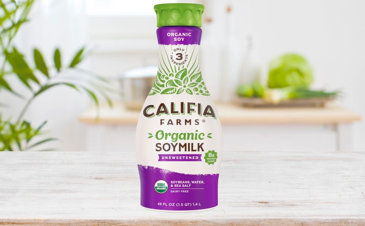 Photo shows a carton of the new Califia Farms soy milk on a wooden countertop in a kitchen