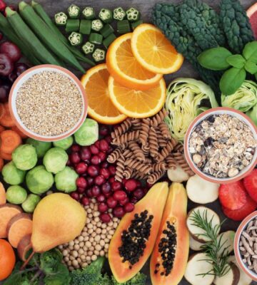 Photo shows a colorful mosaic of fresh fruit, vegetables, nuts, seeds, and other nutrient-dense plant-based foods. Hundreds of doctors and nutrition researchers have called for a return to evidence-based recommendations in the 2025–2030 Dietary Guidelines for Americans (DGA), including the prioritization of plant-based foods over high-impact meat and dairy