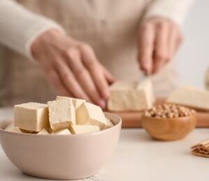 Photo shows someone's hands as they prepare tofu at home in the kitchen. Market Data Forecast predicts that the European tofu market could surpass $2 billion by 2034