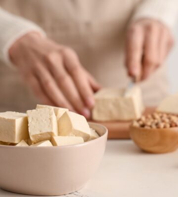 Photo shows someone's hands as they prepare tofu at home in the kitchen. Market Data Forecast predicts that the European tofu market could surpass $2 billion by 2034
