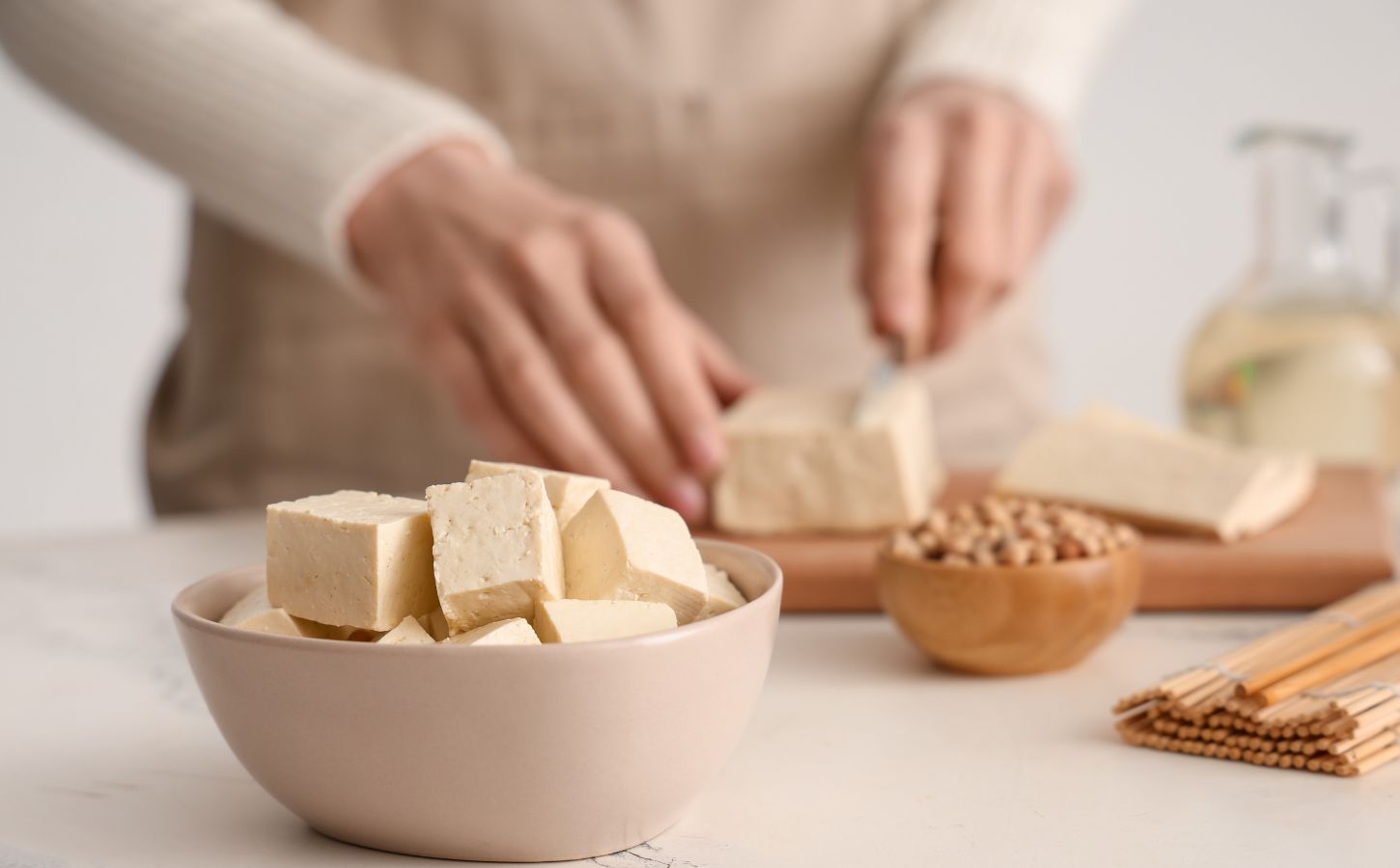 Photo shows someone's hands as they prepare tofu at home in the kitchen. Market Data Forecast predicts that the European tofu market could surpass $2 billion by 2034
