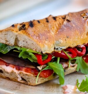 grilled portobello and roasted red pepper sandwich with salad, tomatoes, and shoyu
