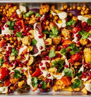 harissa tofu veggie traybake with creamy cashew sauce and pomegranates