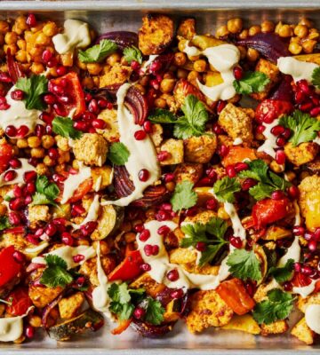 harissa tofu veggie traybake with creamy cashew sauce and pomegranates