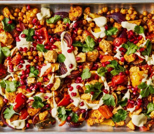 harissa tofu veggie traybake with creamy cashew sauce and pomegranates