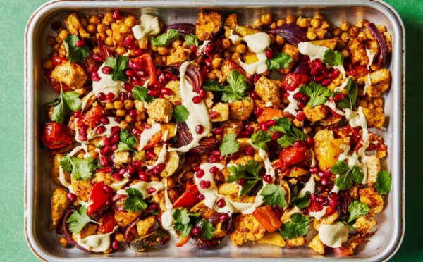 harissa tofu veggie traybake with creamy cashew sauce and pomegranates