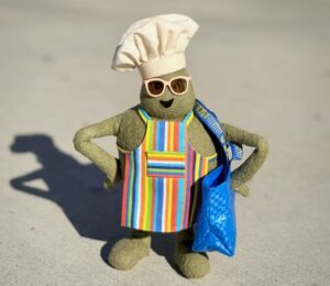 Photo shows "The Chef," the star of 'The Tiny Chef Show,' standing outside of an IKEA and wearing a tiny blue IKEA bag. IKEA has just introduced a new vegan-friendly falafel ball, inspired by its classic meatballs, in collaboration with 'The Tiny Chef Show'