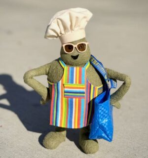 Photo shows "The Chef," the star of 'The Tiny Chef Show,' standing outside of an IKEA and wearing a tiny blue IKEA bag. IKEA has just introduced a new vegan-friendly falafel ball, inspired by its classic meatballs, in collaboration with 'The Tiny Chef Show'