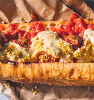 a vegan meatball parmigiana hero with cashew mozzarella, lentil meatballs, and basil for recipes that use nutritional yeast