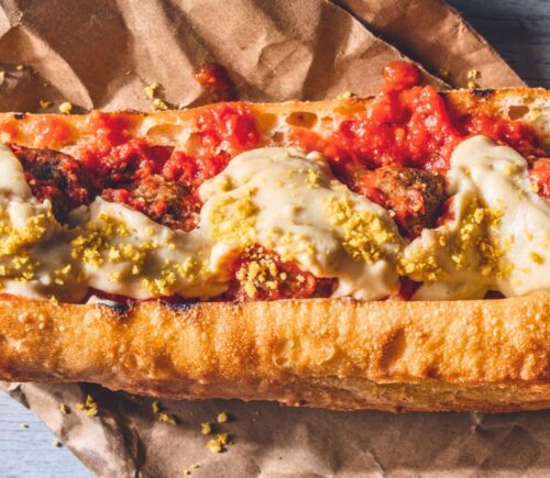 a vegan meatball parmigiana hero with cashew mozzarella, lentil meatballs, and basil for recipes that use nutritional yeast