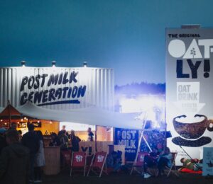 Photo shows a huge Oatly display at a festival that includes the slogan "post-milk generation." Following the Supreme Court's ruling this week, Oatly will no longer be allowed to use the word "milk" at all when marketing or labeling its products in the UK