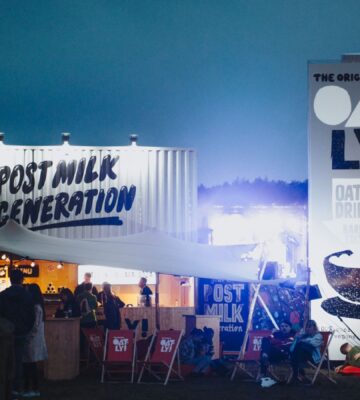Photo shows a huge Oatly display at a festival that includes the slogan "post-milk generation." Following the Supreme Court's ruling this week, Oatly will no longer be allowed to use the word "milk" at all when marketing or labeling its products in the UK