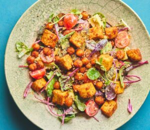 roasted chickpea and tofu salad with tomatoes, avocado, maple syrup, and tahini