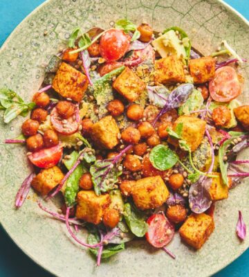 roasted chickpea and tofu salad with tomatoes, avocado, maple syrup, and tahini