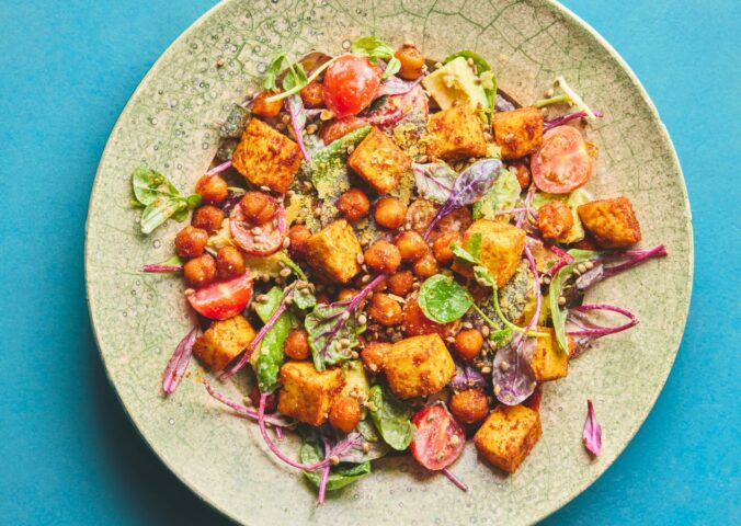 roasted chickpea and tofu salad with tomatoes, avocado, maple syrup, and tahini