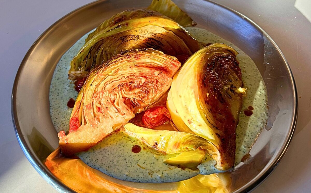 tomato braised cabbage on mint tzatziki with cucumber and lemon