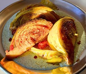 tomato braised cabbage on mint tzatziki with cucumber and lemon