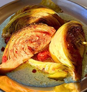 tomato braised cabbage on mint tzatziki with cucumber and lemon