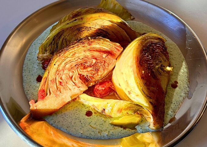 tomato braised cabbage on mint tzatziki with cucumber and lemon