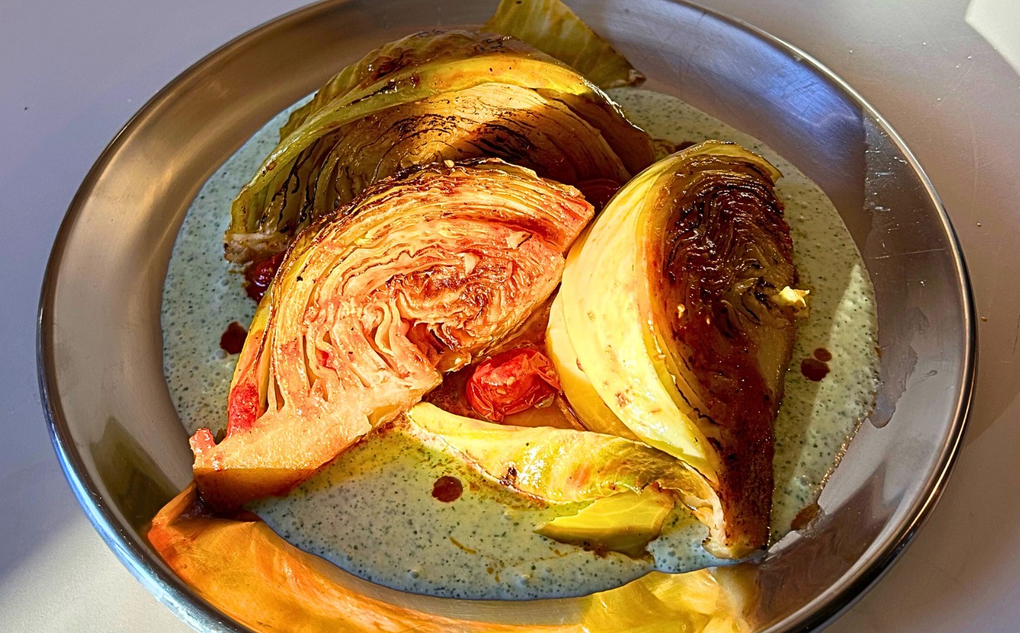 tomato braised cabbage on mint tzatziki with cucumber and lemon