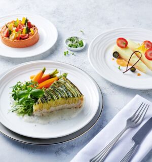 Photo shows the zucchini tart, which is one of the nearly 500 plant-based options now available on Emirates flights. The airline is doubling down on vegan airplane food in 2026